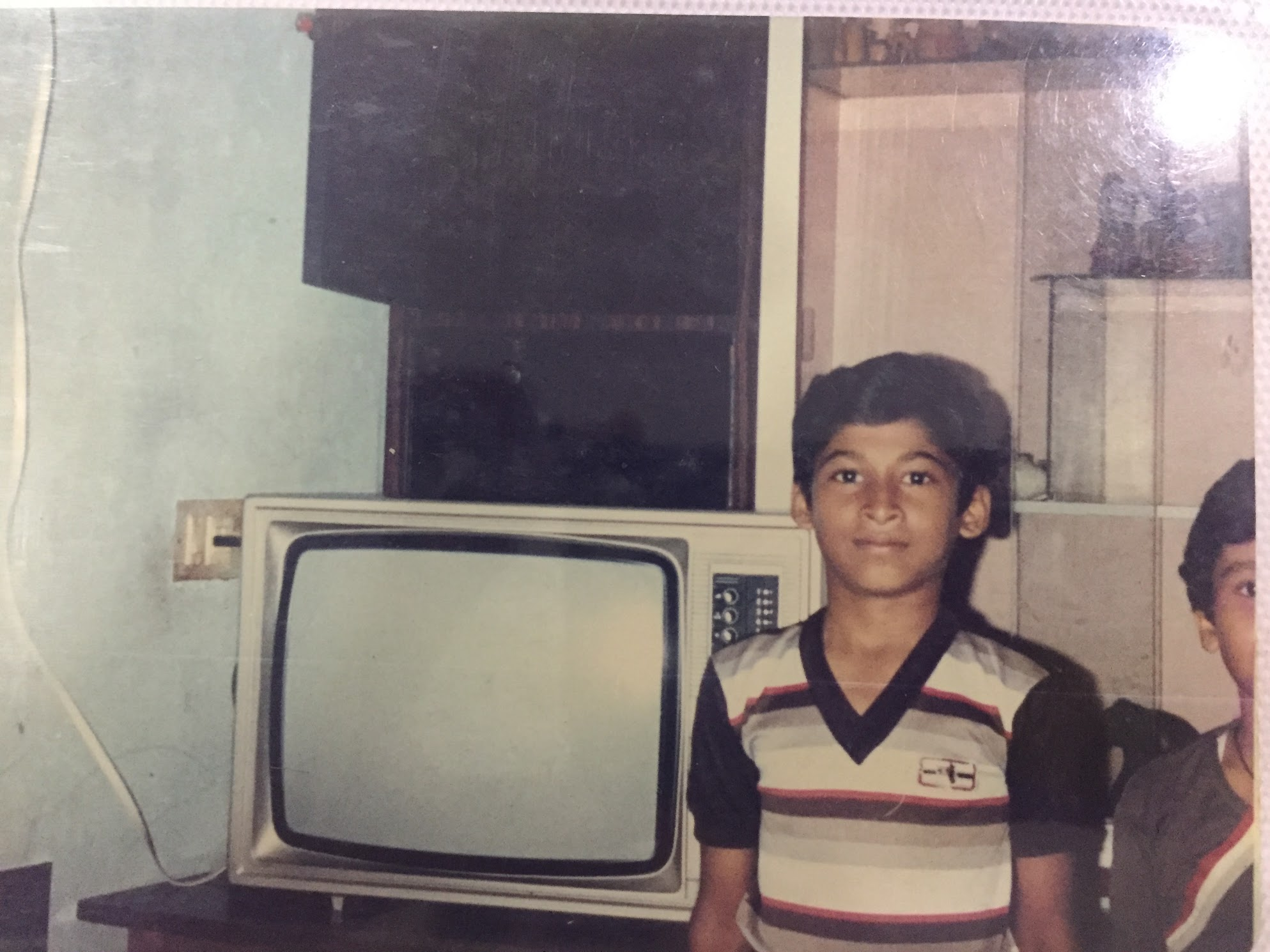 The author and his older brother standing beside a Solidaire television in 1986